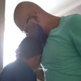 A father comforts his tween son